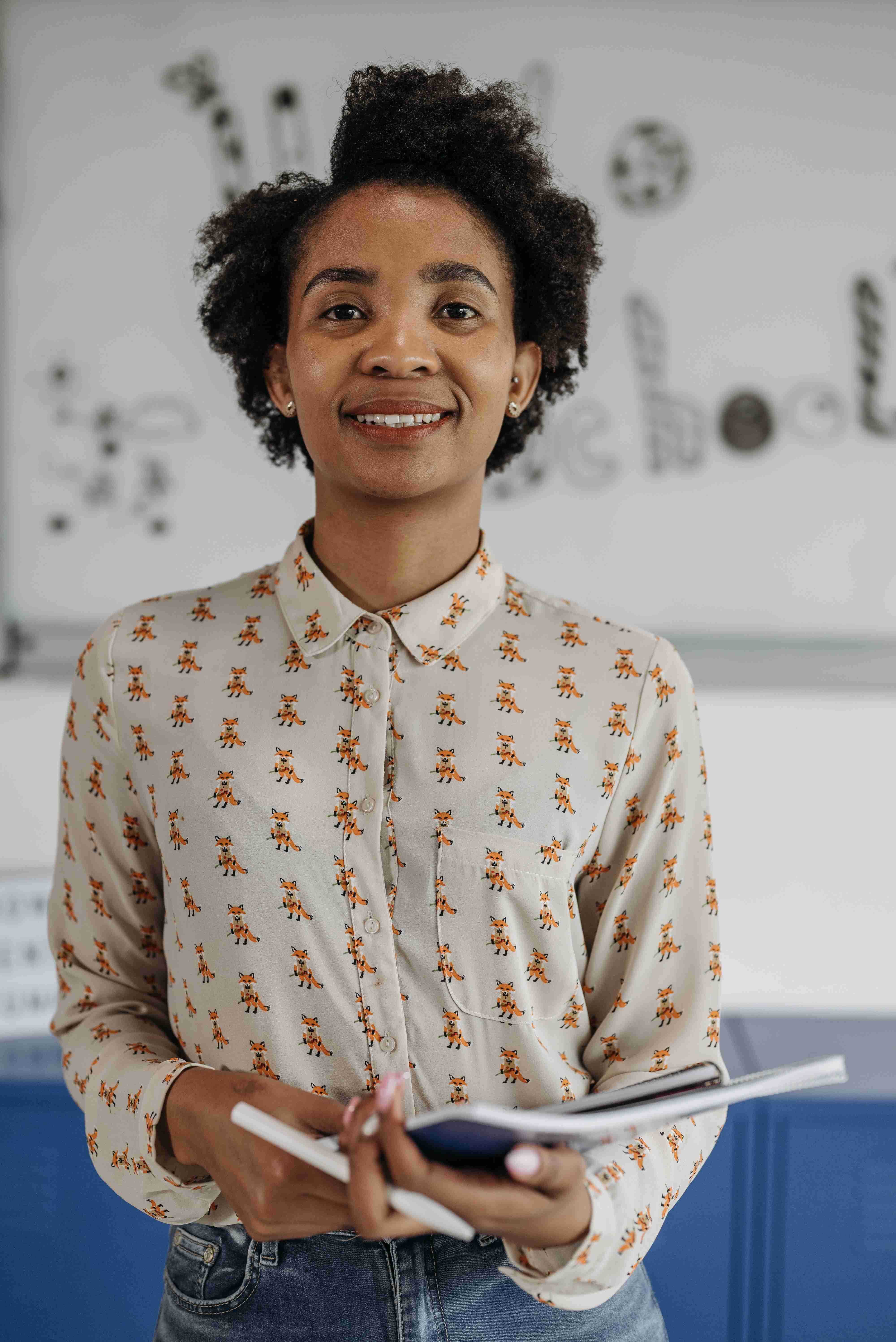 A teacher smiling with learners